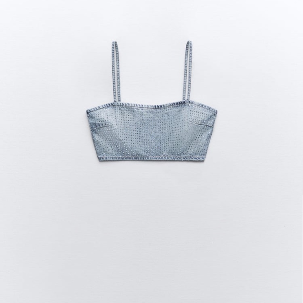 Straight neck crop top with thin straps. Rhinestone details.